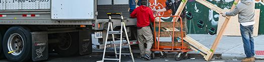 Movers Loading Large Items On Moving Truck